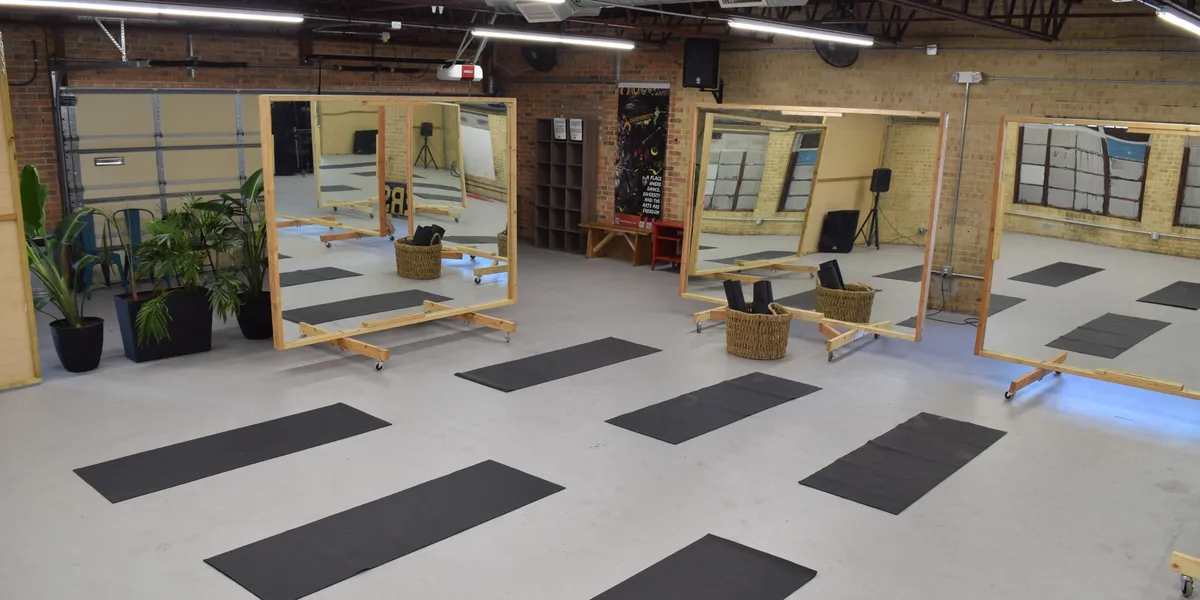 Daytime at Space512 — 2,000 sq ft open floor with rolling mirrors, exposed brick, and natural light
